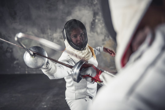 Two women fencing