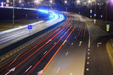 Fototapeta na wymiar Light trails on highway at night, long exposure abstract urban background