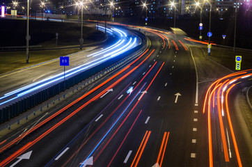 Light trails on highway at night, long exposure abstract urban background