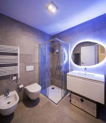 Modern marble bathroom with backlit mirror
