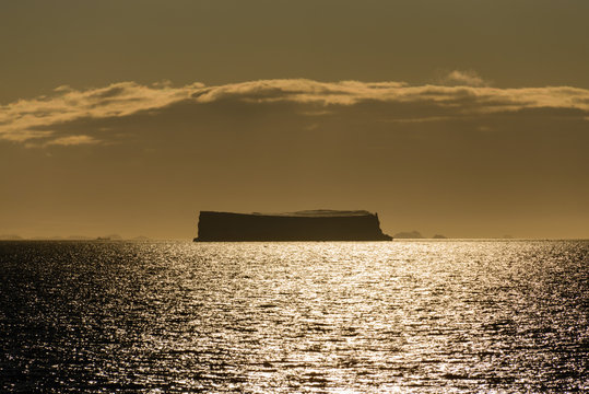 Tabular iceberg at sunset