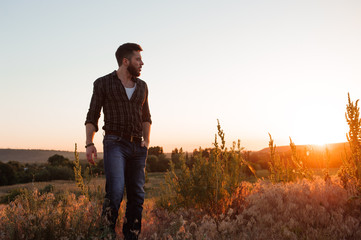 Handsome man on sunset background