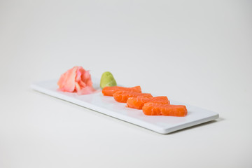 Sushi on a white plate on a white background isolated