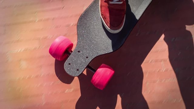 a man's feet on an electric skateboard as it moves along the ground