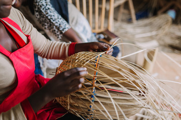woman weaving basked out of bamboo in Rwanda Africa