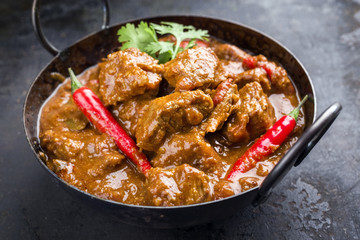Traditional Indian curry lamb masala as close-up in a Korai - obrazy, fototapety, plakaty