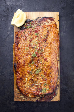 Barbecue Salmon Fillet Marinated On Cedar Plank Wood With Lemon As Overhead View