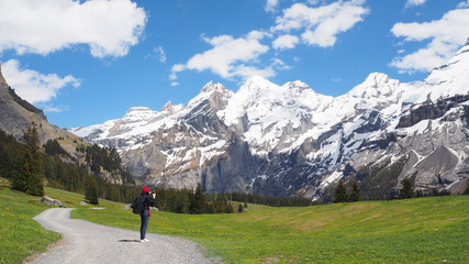 Traveler taking picture of Alps mountain view on the way to Oeschinen lake, Switzerland, May 2017