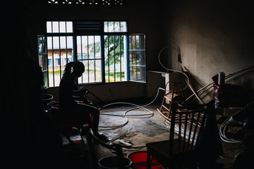 silhouette of woman working at a workshop in Rwanda, Africa
