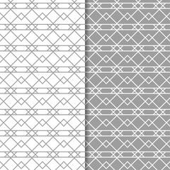 Gray and white geometric ornaments. Set of seamless patterns