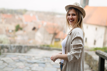 Happy blond female wearing hat outdoor