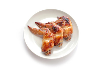 Grilled chicken wings on white plate
