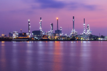 Fototapeta na wymiar Oil refinery at the river in sunrise time / Big Factory in sunrise time