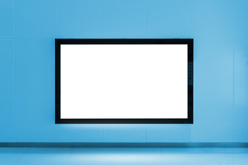 Blank advertising billboard on the wall at subway train station on blue color tone, Text message for commercial