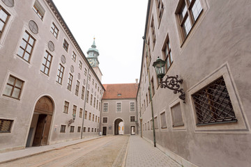 Fototapeta na wymiar Empty street of historical city with old buildings and arches. Bavaria