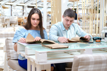 Fototapeta premium Young girl and guy reading carefully, preparing for the exam