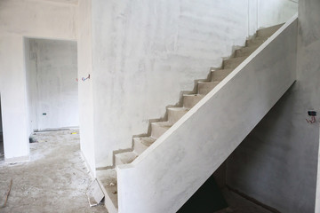 New house construction with concrete staircase at building site