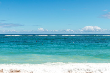Landscape of clear blue ocean and beautiful sky at sunny day. Bali island. Tropical beach.