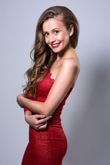 Portrait of a smiling young woman in a red dress