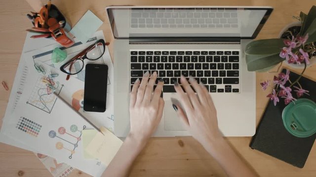 Office desk table with laptop, supplies and disposable cup with coffee