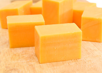 piece of cheese isolated on a wooden board