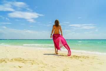 Woman with pink sarong at the beach in Koh Poda island Thailand