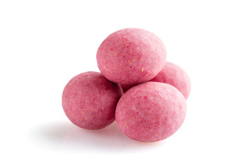 Heap of pink sugared almonds dragees isolated on white background