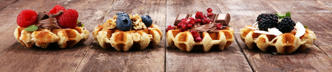 Belgian waffles with pomegranate and raspberries, homemade healthy breakfast with mint