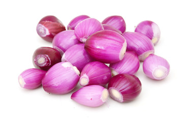 A group of small red pearl onions on a white background.