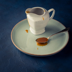 Salted caramel in a spoon on dark background