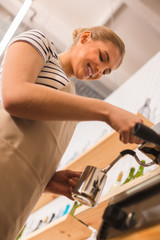 Delighted positive woman preparing coffee