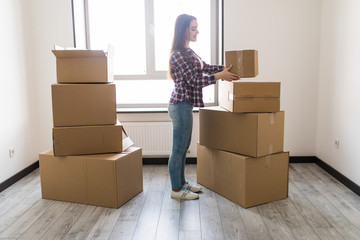 Woman packing and unpacking in a carton box when moving home