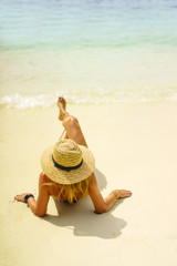 Fototapeta na wymiar Woman with straw hat at the beach in Thailand