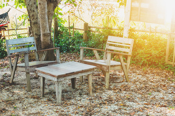 Vintage style wooden table and chair in the garden cafe.