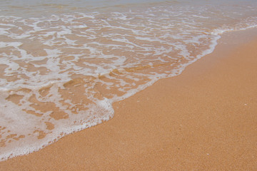 Soft wave of the blue ocean on the seashore of Thailand, copy space on the sand copy space