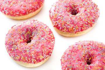 Pink frosted donut with colorful sprinkles. Isolated on white background 
