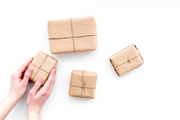 Parcel. Hands take delivered wrapped boxes. White background top view