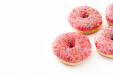 Pink frosted donut with colorful sprinkles. Isolated on white background 
