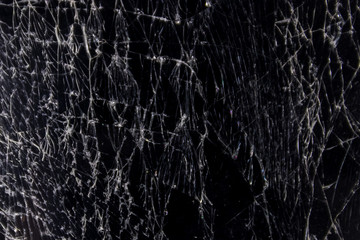 Cracked smart phone screen close-up. Broken glass texture background