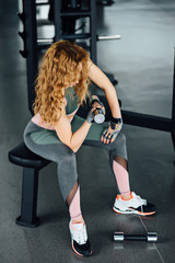 Sporty girl doing exercise with dumbbells.