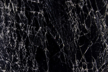 Cracked smart phone screen close-up. Broken glass texture background