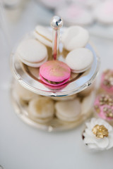 Sweet macaroons on a golden tray