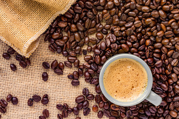 Coffee cup placed on a bed of coffee beans