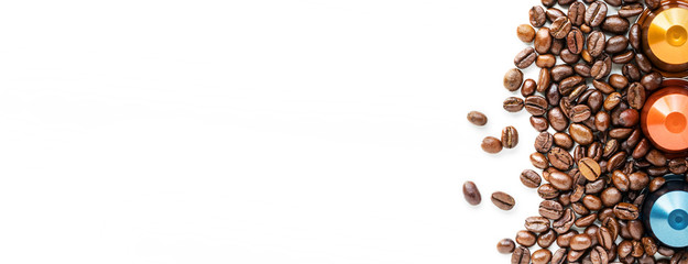 Capsules of Coffee and coffee beans on a white background