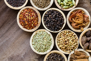 Various whole indian spices on wooden table