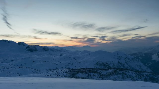 Time lapse of Alpine mountains in winter, beautiful sunset with colored sky