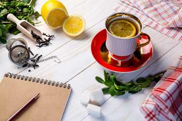 Cap of tea on whit background with mint and lemon