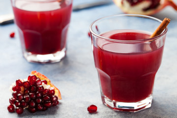 Hot mulled pomegranate cider on a blue stone background