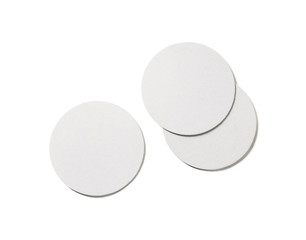Photo of blank beer coasters on white background. Isolated with clipping path. Flat lay. © Veresovich