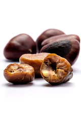 Roasted chestnuts on a white background.